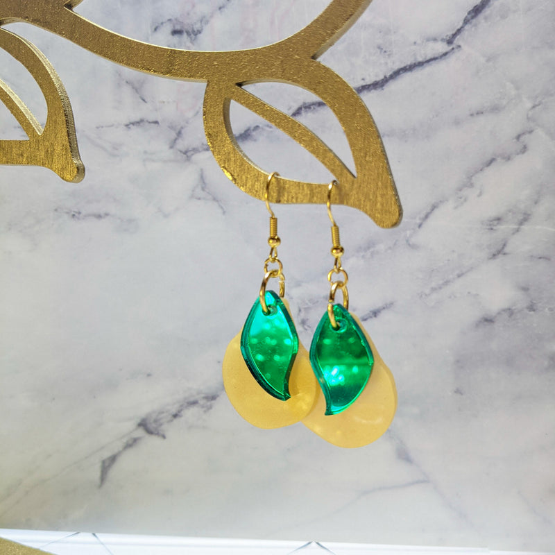Pear earrings hanging off a display 