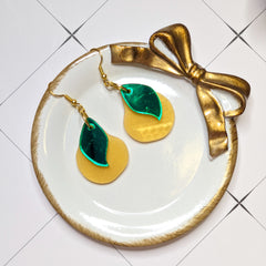 Pear earrings on a jewelry dish